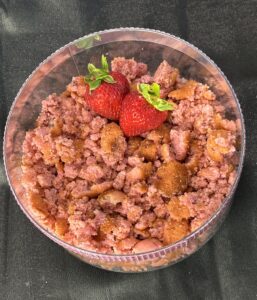 A bowl of strawberry muffin crumbles